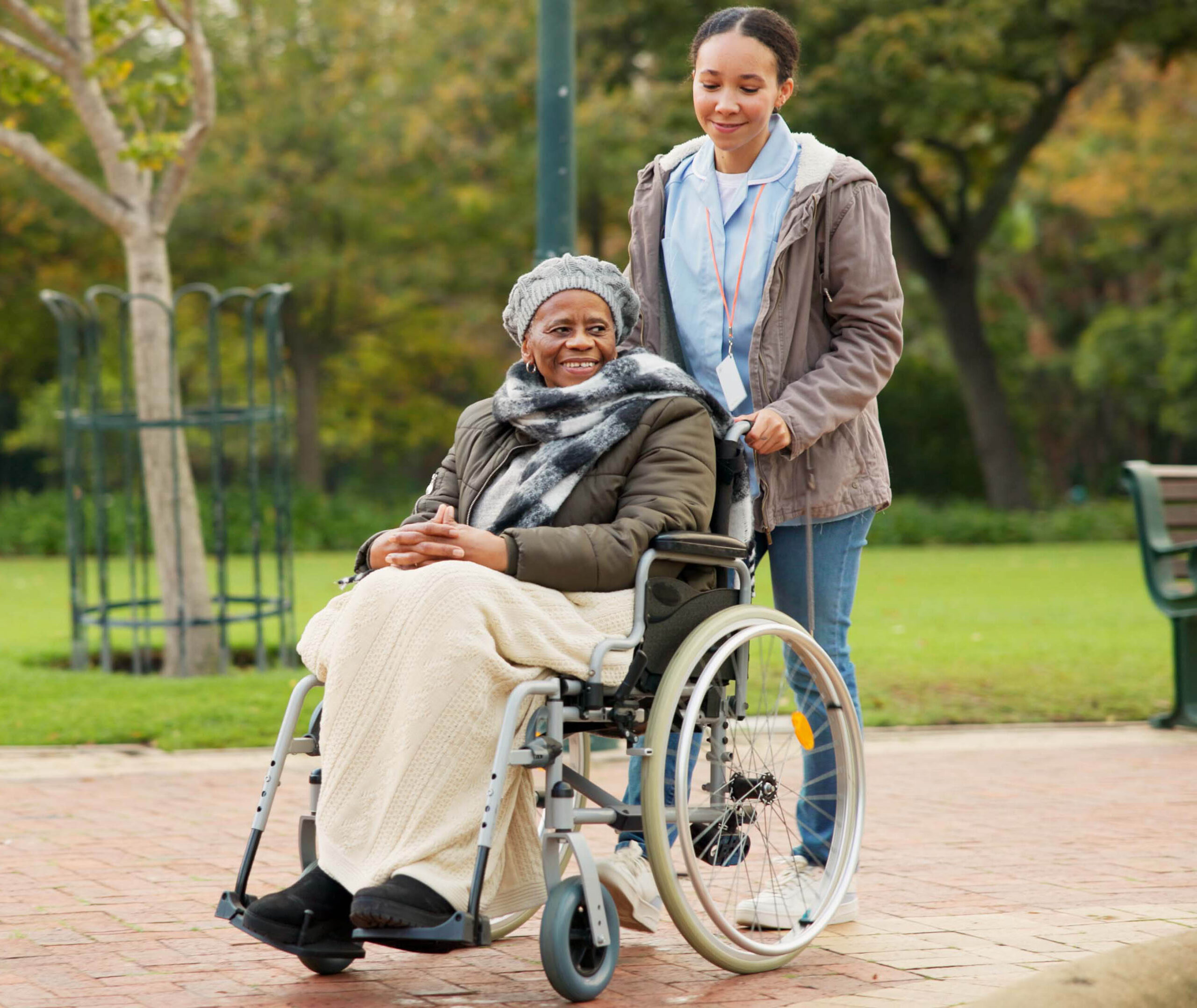 nurse, peace and park with old woman in a wheelchair for retirement, elderly care and physical therapy. trust, medical and healthcare with african patient and caregiver in nature for rehabilitation